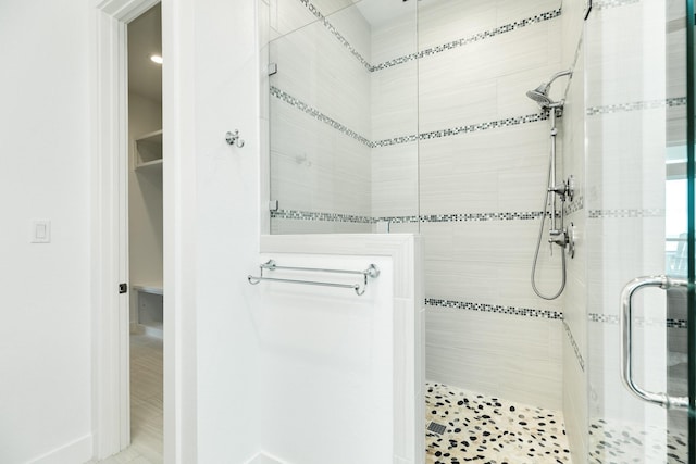 bathroom with a shower with shower door