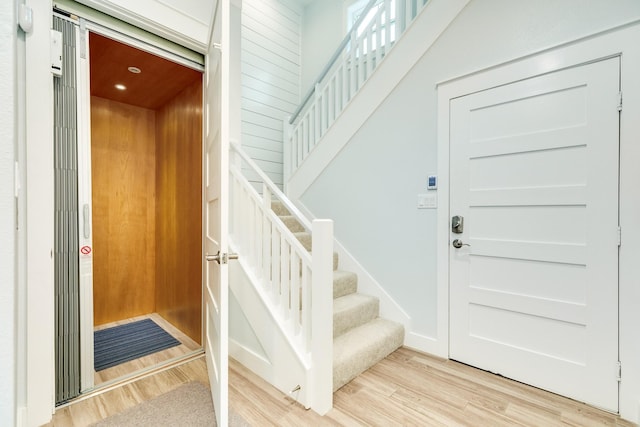 interior space featuring elevator and light hardwood / wood-style flooring