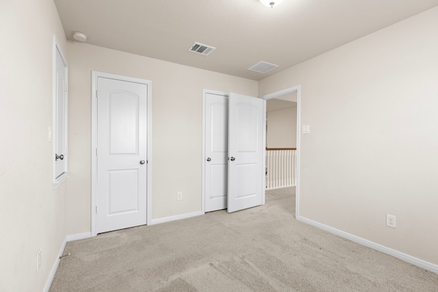 unfurnished bedroom with light carpet