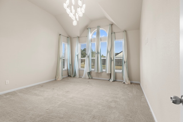 carpeted empty room with lofted ceiling