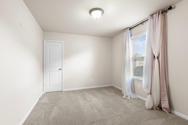 unfurnished room with light carpet