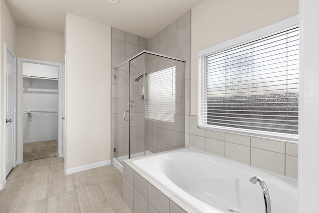 bathroom featuring independent shower and bath and tile patterned flooring