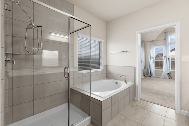 bathroom with tile patterned flooring and shower with separate bathtub