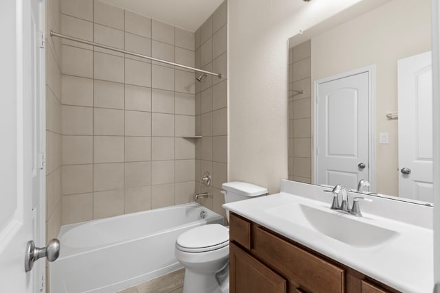 full bathroom with vanity, toilet, and tiled shower / bath combo