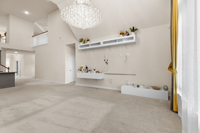 carpeted living room featuring a towering ceiling and a chandelier