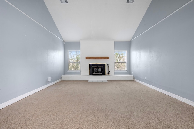 unfurnished living room featuring high vaulted ceiling, carpet flooring, a wealth of natural light, and a fireplace