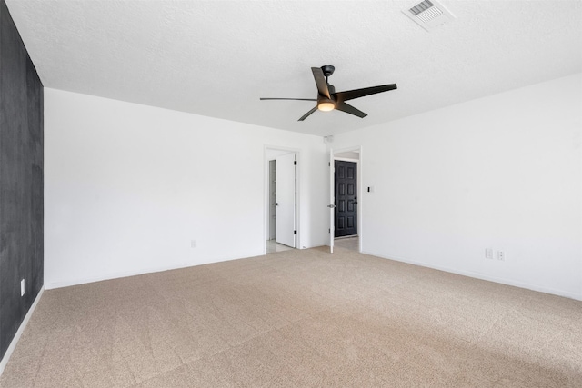 carpeted spare room with ceiling fan and a textured ceiling