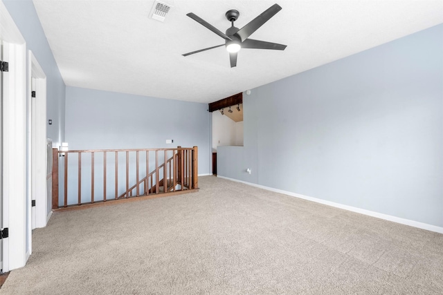 carpeted empty room featuring ceiling fan and lofted ceiling