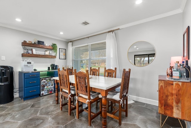 dining area featuring crown molding