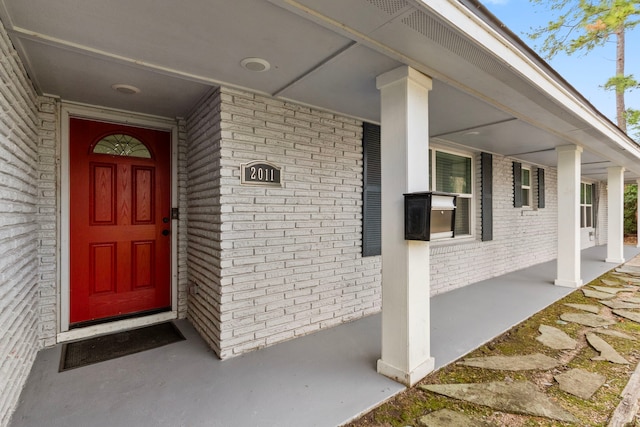 view of exterior entry with a porch