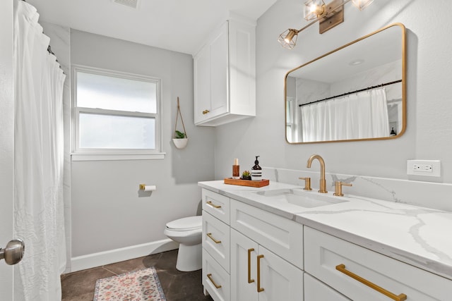 bathroom featuring vanity, tile patterned floors, and toilet