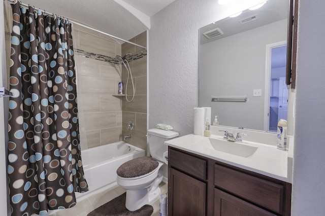 full bathroom with shower / tub combo with curtain, visible vents, a textured wall, toilet, and vanity