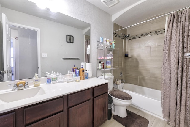 bathroom featuring toilet, shower / bathtub combination with curtain, visible vents, and vanity