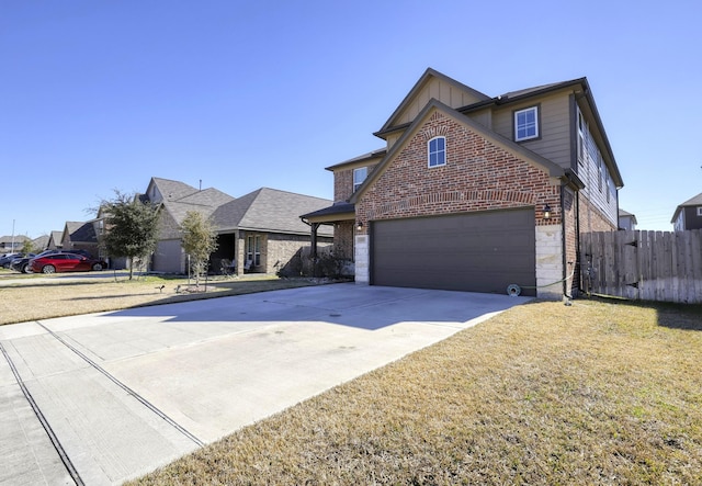 traditional home featuring an attached garage, brick siding, fence, driveway, and a front yard