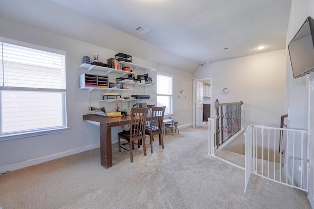 office featuring recessed lighting, light colored carpet, visible vents, vaulted ceiling, and baseboards