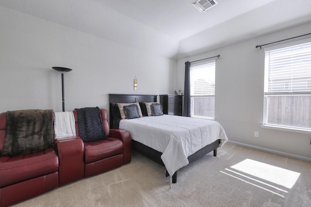 carpeted bedroom with vaulted ceiling, visible vents, and baseboards