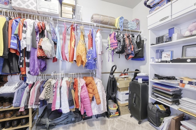 walk in closet featuring carpet floors