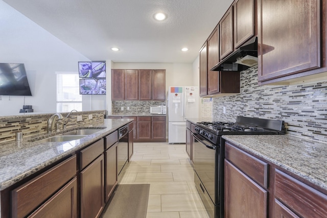 kitchen featuring light stone counters, a sink, under cabinet range hood, and black appliances