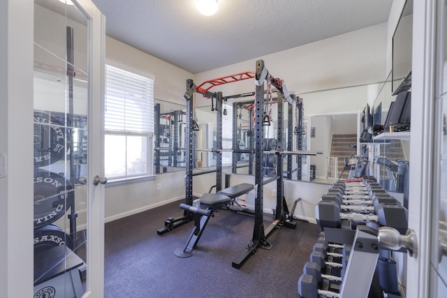 exercise room featuring a textured ceiling