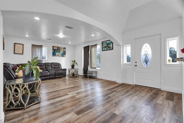 foyer featuring lofted ceiling and wood-type flooring