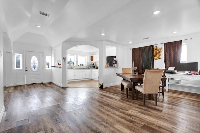 dining space featuring hardwood / wood-style flooring and lofted ceiling