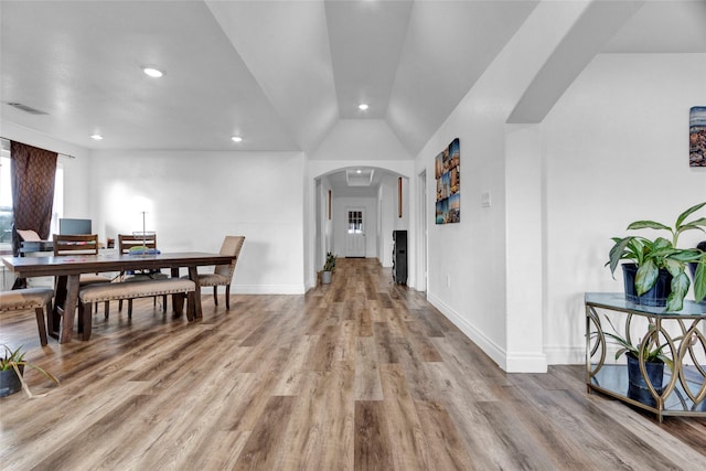 dining area with lofted ceiling and wood-type flooring