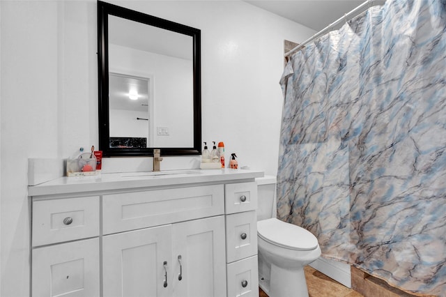 bathroom featuring walk in shower, vanity, and toilet