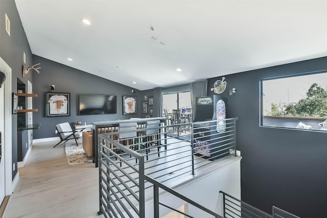 interior space with lofted ceiling, hardwood / wood-style floors, and a wealth of natural light