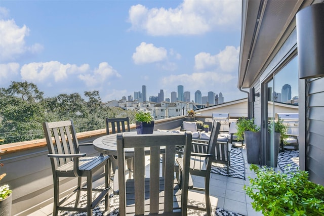 wooden terrace featuring an outdoor living space and a grill