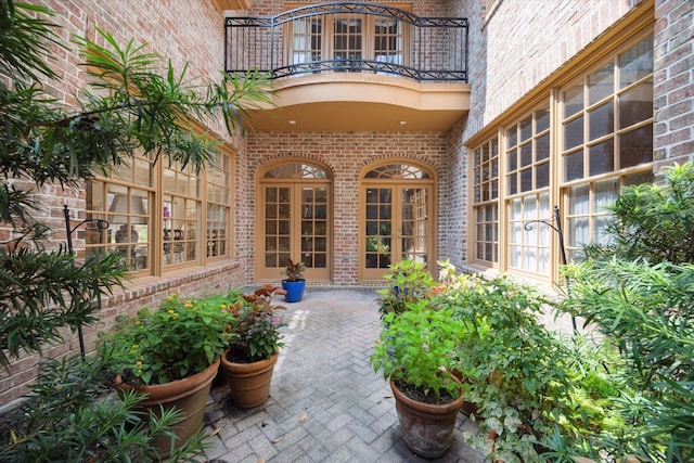 view of exterior entry featuring a balcony