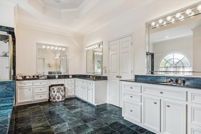 bathroom with ornamental molding, vanity, and a tray ceiling