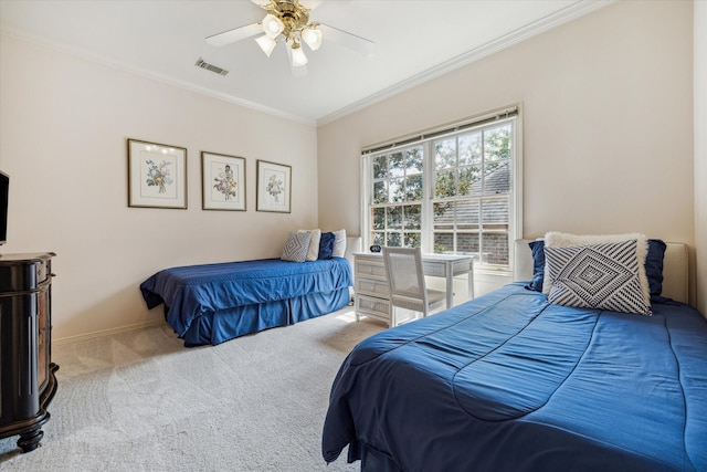 bedroom with ornamental molding, ceiling fan, and carpet