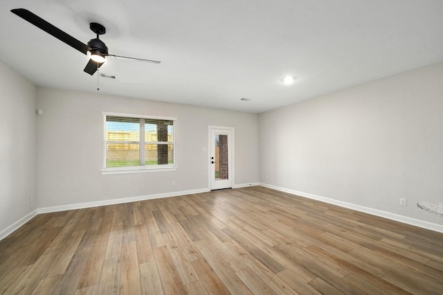 empty room with ceiling fan and light wood-type flooring