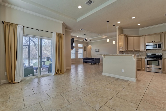 kitchen featuring appliances with stainless steel finishes, pendant lighting, light brown cabinetry, ornamental molding, and a tray ceiling