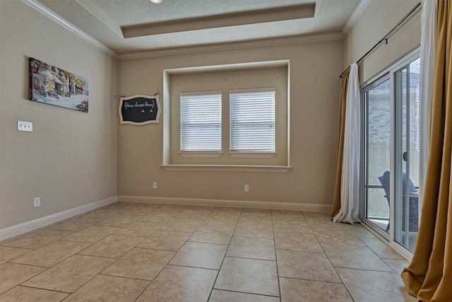 empty room with a raised ceiling, crown molding, plenty of natural light, and light tile patterned flooring