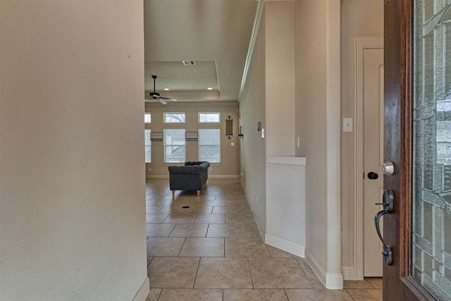 entrance foyer featuring ceiling fan, a raised ceiling, and light tile patterned floors