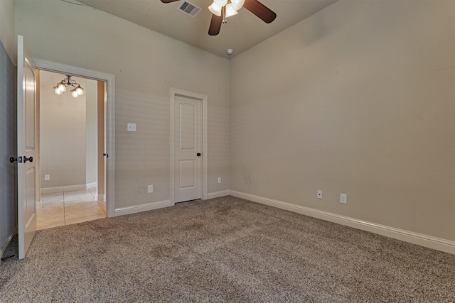 unfurnished bedroom featuring ceiling fan and light colored carpet