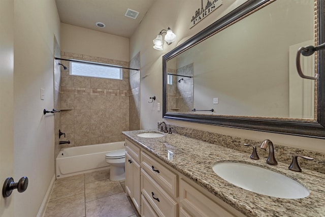 full bathroom with vanity, tile patterned flooring, toilet, and tiled shower / bath