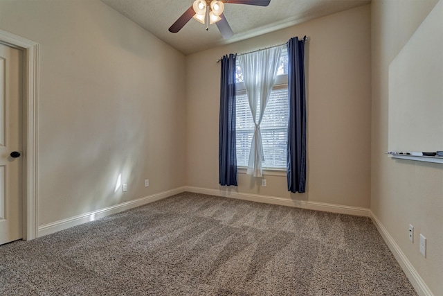 empty room featuring a wealth of natural light, vaulted ceiling, ceiling fan, and carpet flooring