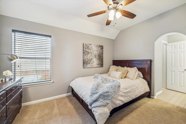 bedroom featuring lofted ceiling, light colored carpet, and ceiling fan