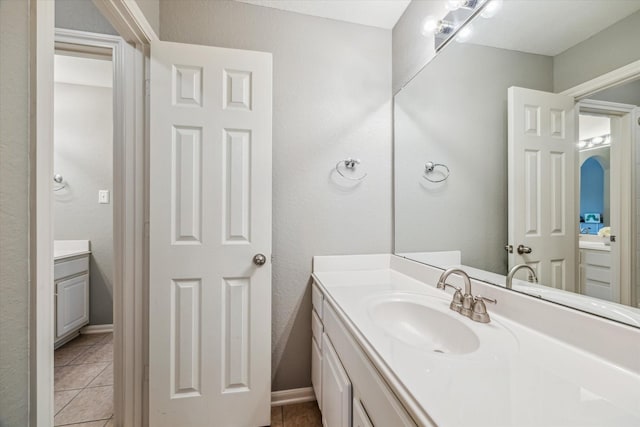 bathroom with tile patterned flooring and vanity