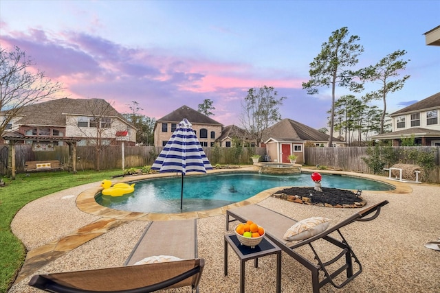 pool at dusk featuring a storage shed