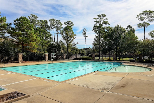 view of swimming pool featuring a patio area