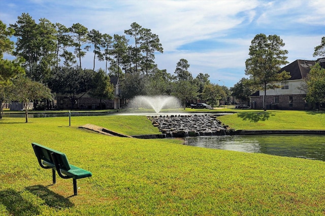 surrounding community featuring a yard and a water view