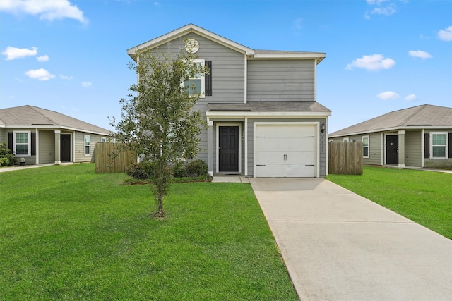 traditional-style home featuring a front yard, concrete driveway, fence, and an attached garage