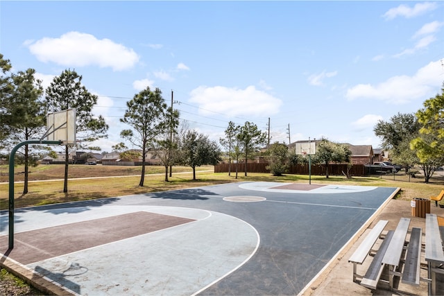 view of sport court featuring community basketball court, a lawn, and fence