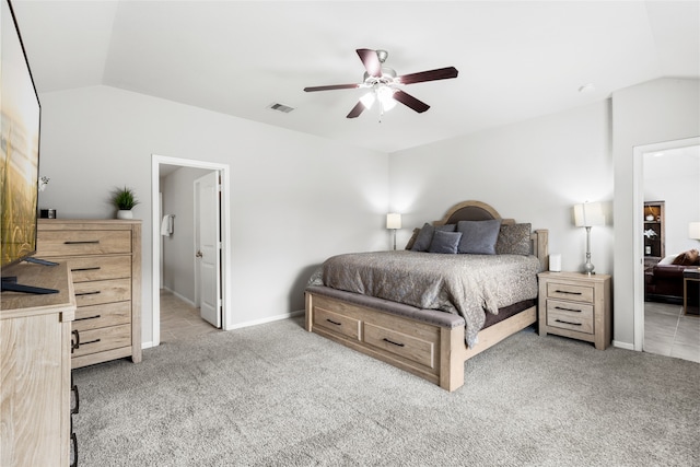 bedroom featuring lofted ceiling, baseboards, visible vents, and light colored carpet