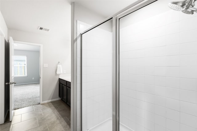 bathroom with baseboards, visible vents, vanity, and a shower stall