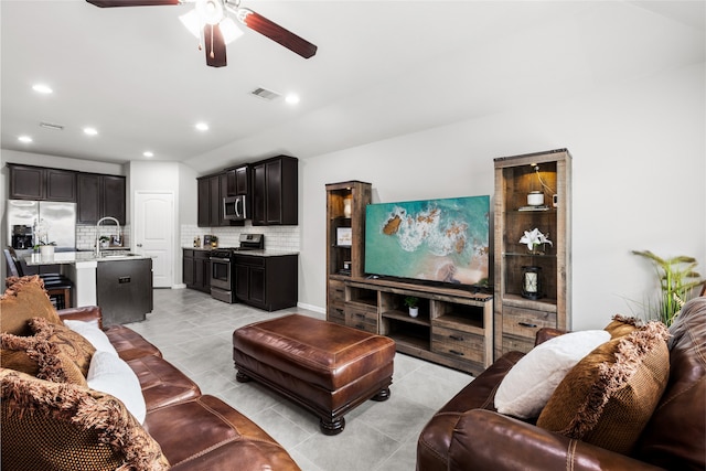 living room featuring light tile patterned flooring, ceiling fan, visible vents, and recessed lighting