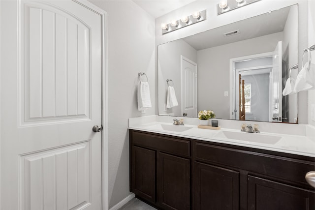 bathroom with a sink and double vanity